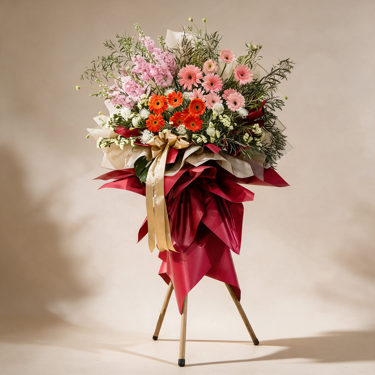 Thrive grand opening flower stand of pink and orange gerbera daisies, matthiola and yellow statice