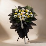 Tranquil condolence flower stand of yellow gerbera daisies and white pompom chrysanthemums