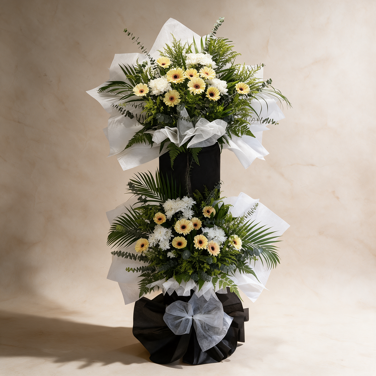 Tribute two-tier condolence flower stand of cream daisies and white pom chrysanthemums