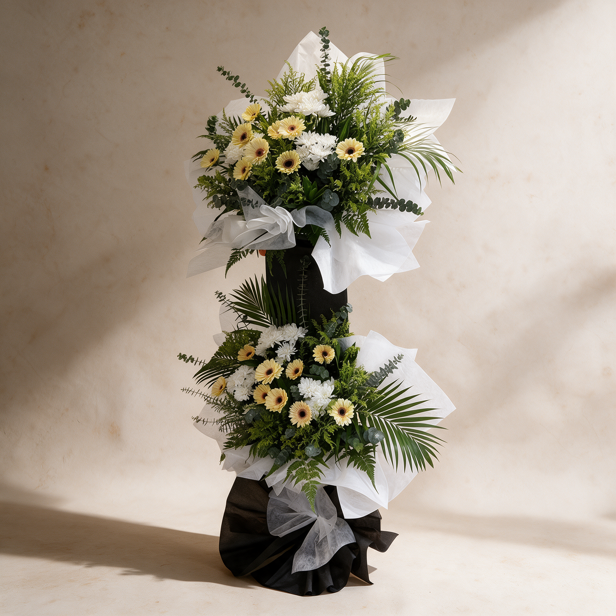 Side view of the Tribute two-tier funeral flower stand of daisies and chrysanthemums