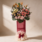 Triumph grand opening flower stand of bird of paradise, gerberas and pink roses