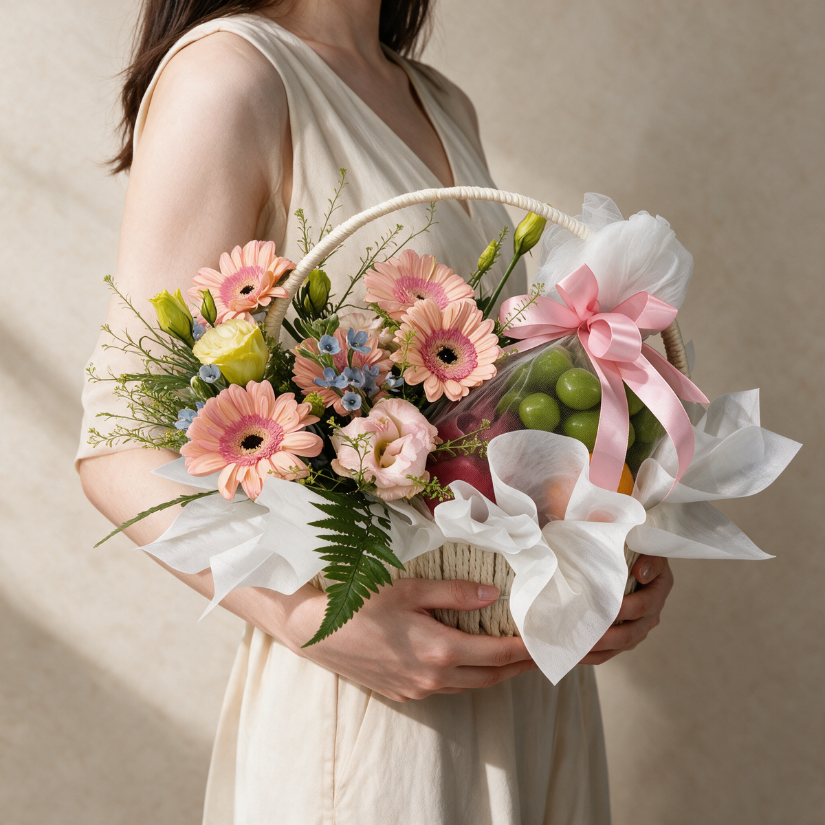 Woman holding the Wishful fresh flower and fruit basket